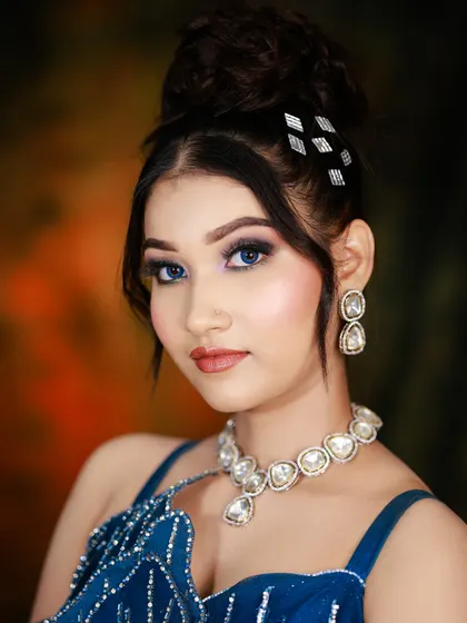 A close-up portrait of the party makeup, featuring a smokey eye and a neutral lip.
