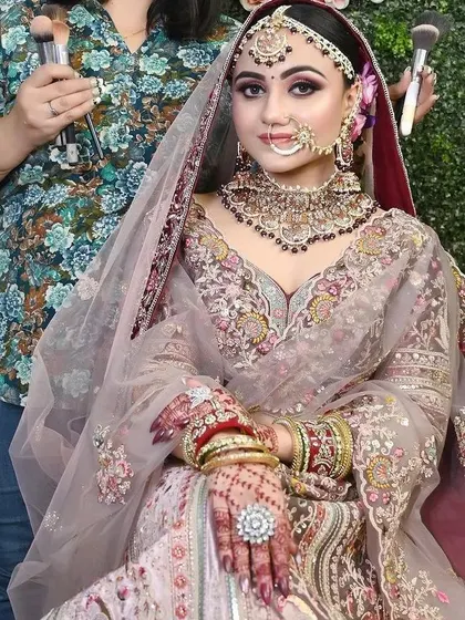 A behind-the-scenes shot of a bride getting ready. She is wearing one of my rental jewellery sets, which includes a heavy choker, nath, and maang tikka, to complete her look.