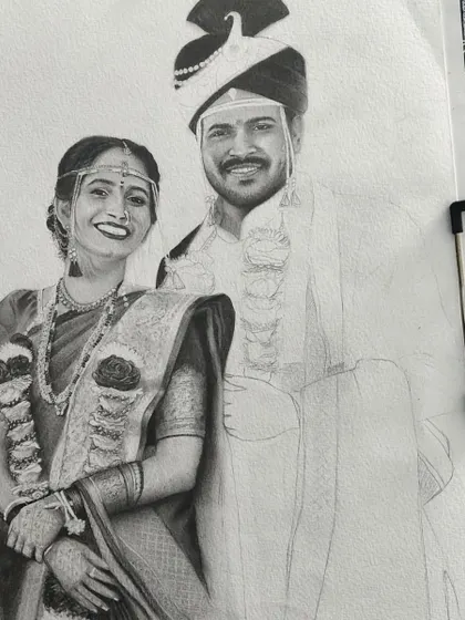 This image shows the wedding portrait clipped to my drawing board. The bride is complete, and I am beginning to add the initial shading to the groom's portrait.