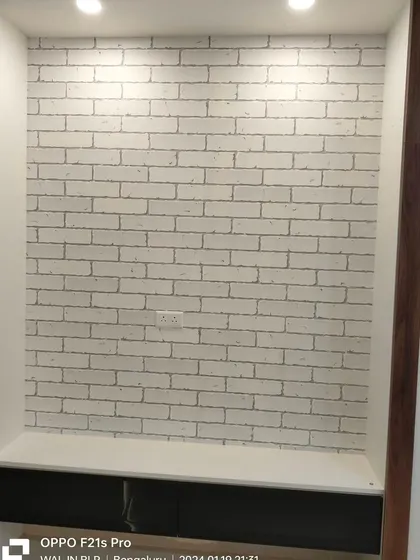 A white brick wallpaper used as a background for a TV niche.