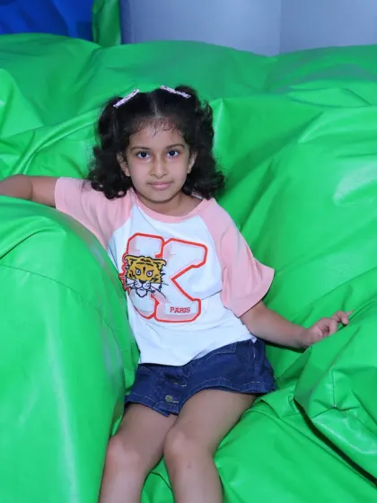 A duplicate of image 17, showing a girl relaxing on a green inflatable.