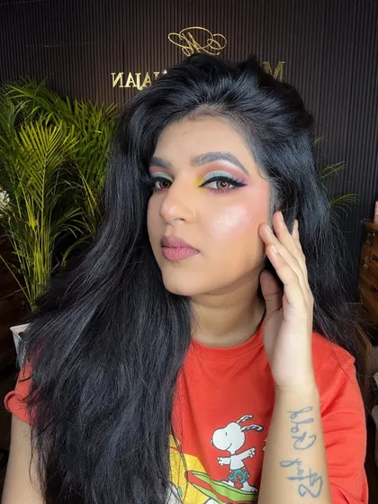 A confident pose showcasing the colorful eye makeup.