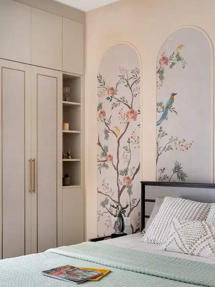 I believe in adding soulful, personal touches to every project. In this bedroom, hand-painted murals of birds and blossoms within arched panels create a unique, artistic focal point, complemented by custom muted cabinetry for a tranquil and elegant retreat.