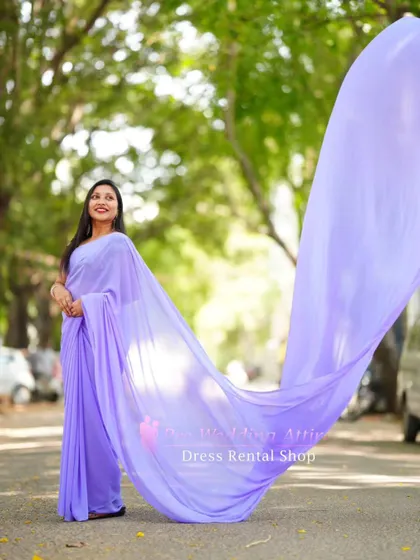 The lavender trail saree's pallu flying high, creating a dramatic effect.