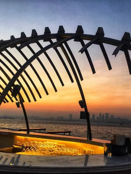 A close-up of the sculptural bar canopy on the Queensline Sea Yah against the sunset. This element was custom designed and fabricated to serve as the centerpiece of the upper deck, creating a memorable visual landmark for guests.