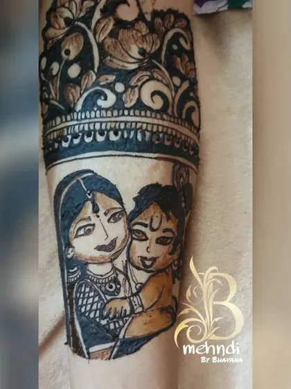 A close-up of a sweet moment captured in henna, showing Yashoda holding Bala Krishna. It's these little details that add so much love to a seemantha design.