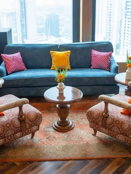 A comfortable lounge area at the Mehendi, with a stunning view of the city skyline. We used colorful cushions to add a pop of festivity to the elegant furniture, blending comfort with celebration.