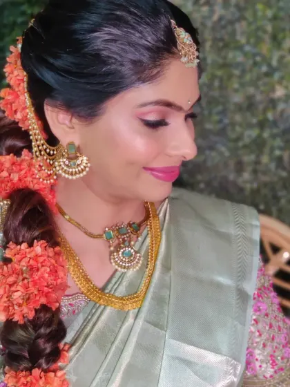 A close-up of Keerthana's baby shower makeup, featuring shimmery eyes and a traditional floral braid.