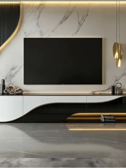 An ultra-modern and sculptural TV unit featuring a glossy, curved console in black and white. The white marble wall behind the television adds a layer of luxury, while gold accents provide a touch of warmth.