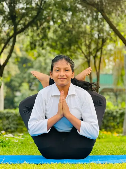 Balance is something you create. This young student finds her center in this beautiful and complex seated balancing pose.