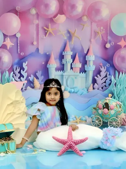 We bring fairy tales to life with our enchanting 'Little Mermaid' setup. This elaborate underwater scene features a castle, pastel balloons, and shimmering seashells, creating a magical world for your child's portrait.
