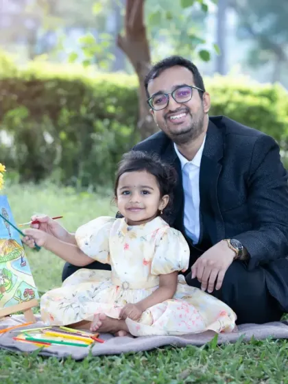 A sweet father-daughter moment, creating a painting together on a picnic blanket in a park. My sessions are about making memories, not just posing for them.