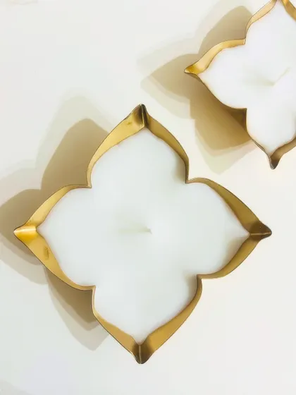 A simple, elegant quatrefoil-shaped urli candle. This design is timeless and fits beautifully with modern festive decor.