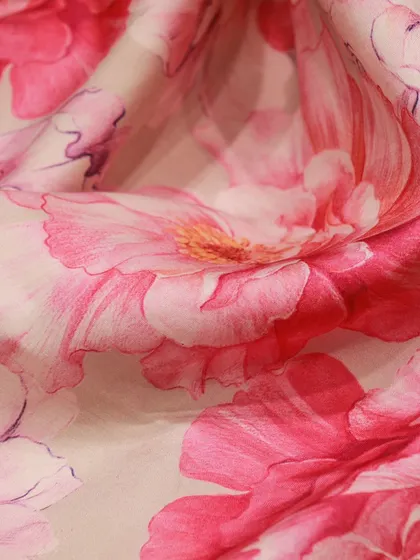 A close-up of the vibrant pink floral print, which gives the traditional Kanjivaram a fresh, modern feel.