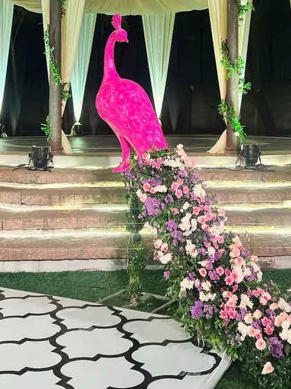 A close-up of the magnificent pink peacock prop, a custom creation that added a unique and artistic flair to the sangeet decor.