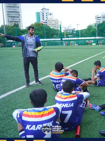A coach instructs his team during a break in play, highlighting our tactical approach.