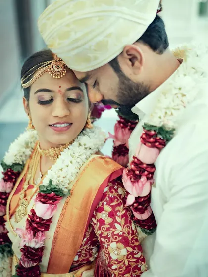 An intimate close-up of a South Indian couple, capturing a tender moment during their wedding ceremony.