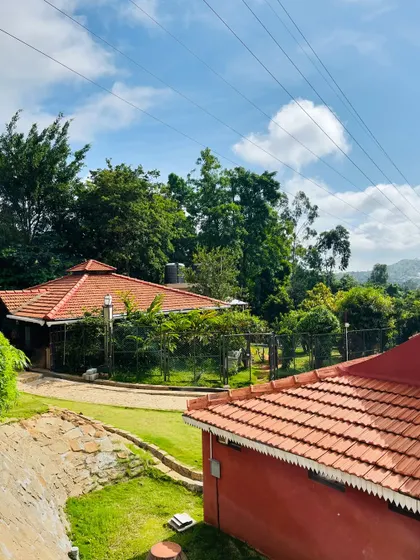 A beautiful sunny day at our Nandi Hills resort, with blue skies and green landscapes creating a perfect day-outing vibe.