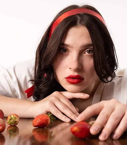 A direct gaze from the same strawberry-themed shoot. This shot breaks the fourth wall, inviting the viewer into the conceptual world we created.