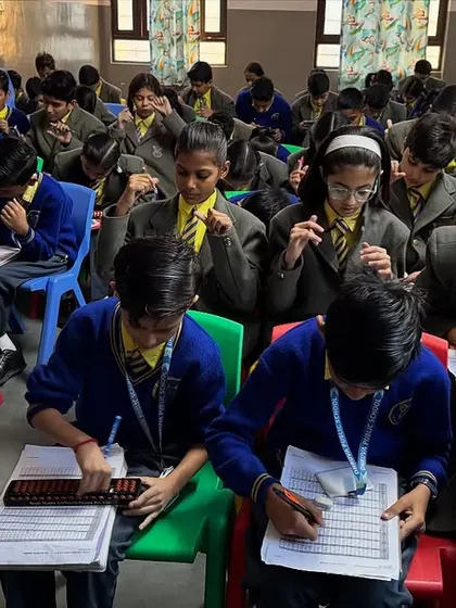Students using both mental math and the abacus during a practice test at Dhruva Public School.