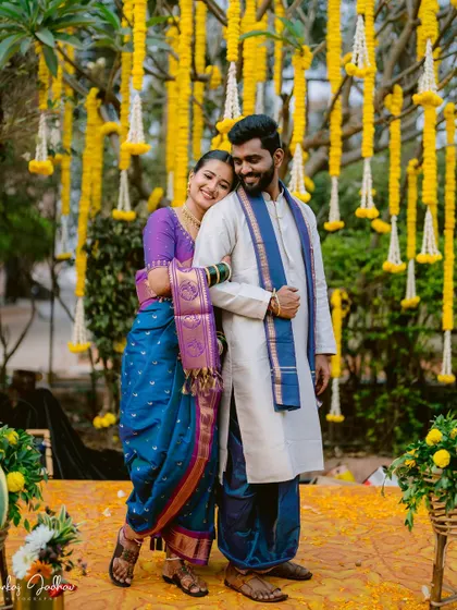 A beautiful portrait of Ruchi and Sanket under a canopy of marigolds.