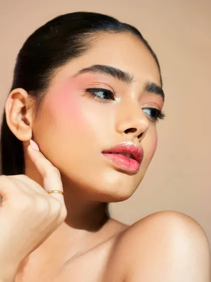 A perfect example of a "no-makeup" makeup look, where the skin is the absolute focus.