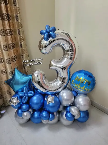 A 3rd birthday balloon bouquet in blue and silver chrome colors.