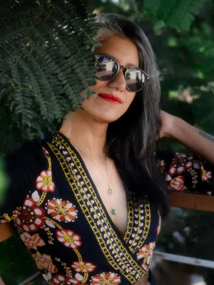 A close-up of the floral jumpsuit look, showing how even a casual outfit can feel polished with the right attitude.