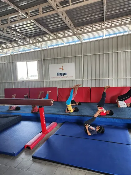 Students practice the plow pose, a deep stretch for the entire spine and shoulders, which helps improve overall flexibility.