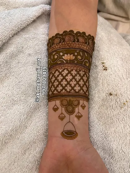A creative arm band design that incorporates a 'tarazu' or weighing scale motif, a unique and symbolic element.
