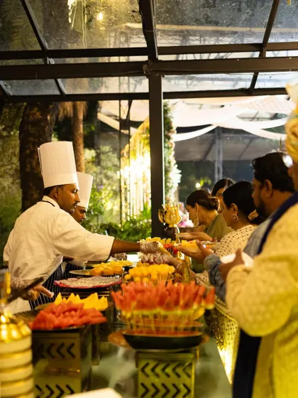 Guests line up at a vibrant live station offering a variety of freshly prepared dishes.