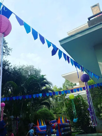 Another view of the festive outdoor setup, showcasing the hanging lanterns and colorful banners that help define the party space and create a fun, whimsical environment.