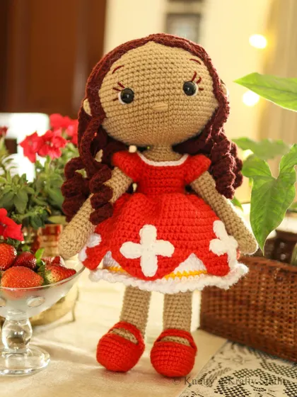 Handmade with love, meet Lily. This little crochet doll is dressed in her festive red dress, ready to be tucked into a Christmas stocking for someone special.