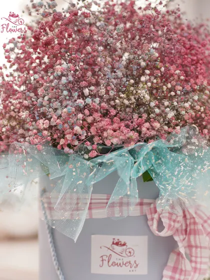 A closer look at the colorful gypsophila bouquet. The mix of pink and blue hues creates a whimsical, cotton-candy effect, perfect for a lighthearted and joyful occasion.