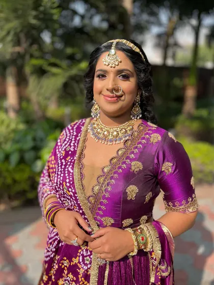 Another angle of this lovely purple-toned look. The soft, curly hairstyle adds a touch of romance and balances the vibrant colors of her outfit.