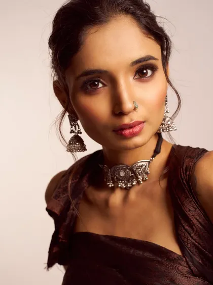 A close up on a modern ethnic look. I paired a soft smokey eye with a subtle lip, allowing the beautiful silver jewelry to stand out. The hairstyle is a textured updo, keeping the focus on the face.