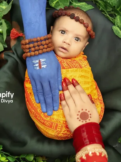 A divine blessing. This conceptual newborn portrait represents the protection of Lord Shiva and Parvati over a precious new life. It's a powerful and artistic way to celebrate a baby born during the holy month of Saavan.