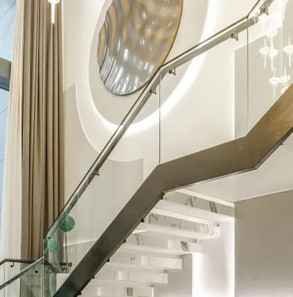 A detail of the floating staircase in our Vikaspuri project. The combination of white marble treads, a glass railing, and a metallic art piece creates a sculptural and light-filled circulation space.