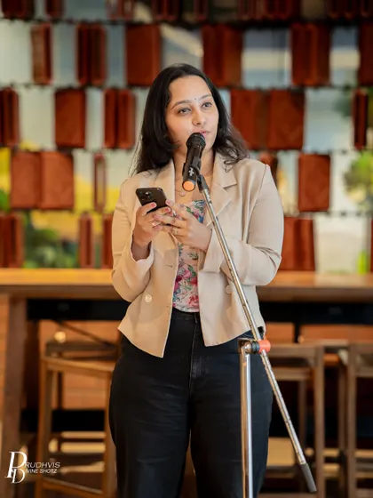 A performer shares her story with a serious and heartfelt expression. Our themed events often bring out deep and personal narratives from our community members.