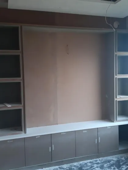 The framework for a large storage and display unit in an office. This work-in-progress shot shows the underlying structure before painting and finishing, highlighting the importance of solid carpentry.