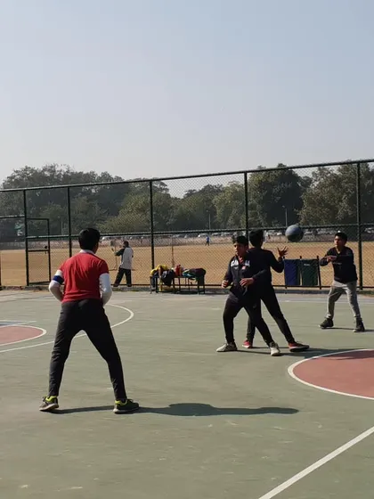 This action shot shows a defensive and offensive drill. We teach players how to maintain proper defensive stance while challenging the ball handler, a key element of smart team defense.