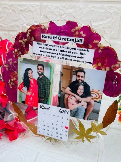 This piece shows how versatile resin art can be, combining photos, text, a calendar, and even lights into one cohesive design.