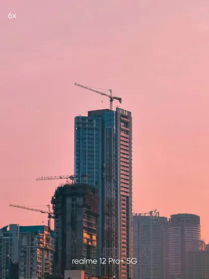 A tight 6x zoom shot of a skyscraper under construction against a pink sky. This mobile photo highlights my skill in using zoom to isolate interesting subjects and create abstract architectural portraits.