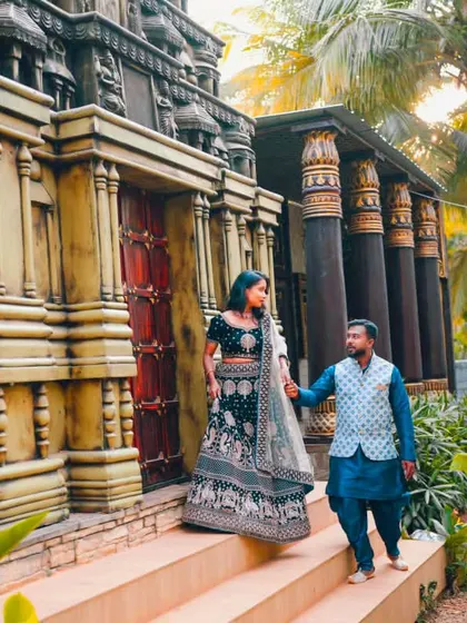 Capturing a grand moment. The couple walks down the steps of a temple-like structure, showcasing the elegant traditional wear I styled for their pre-wedding shoot.