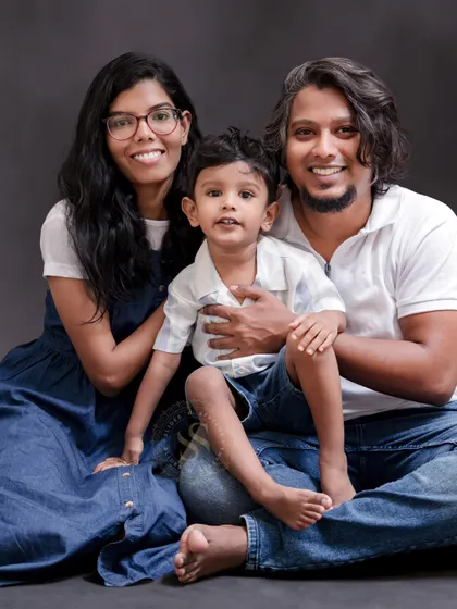 A relaxed, casual family portrait with everyone seated on the floor. We encourage poses that feel natural and reflect your family's personality.