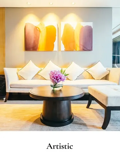 An interplay of warm tones and soft textures gives this space a quiet sophistication. The abstract artwork and clean-lined furniture create a contemporary yet inviting living area.