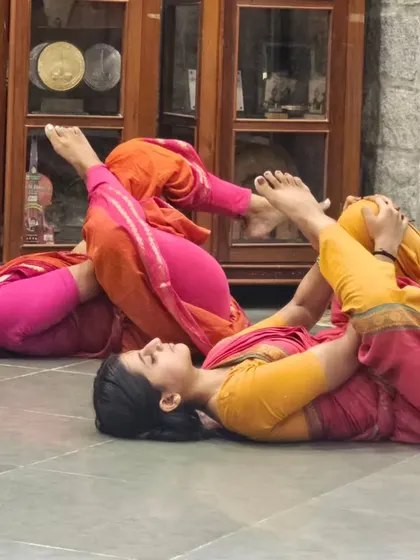 Training is not just about physical rigor; it's also about finding balance and rest. My students are seen here in a relaxation pose after an intense Adavu session.