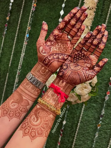 A side-by-side look at the front and back of this bridal mehendi. The back features simpler elephant and geometric patterns, complementing the intricate design on the palms.