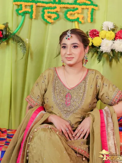 A lovely portrait of the bride, capturing her serene expression as she gets her Mehndi done.