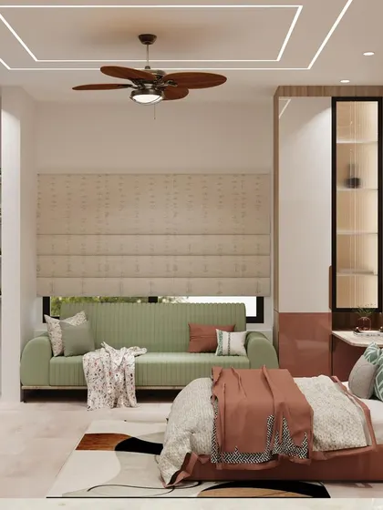 A spacious master bedroom with a soft green sofa, a large bed, and a stunning pink marble-finish accent wall.